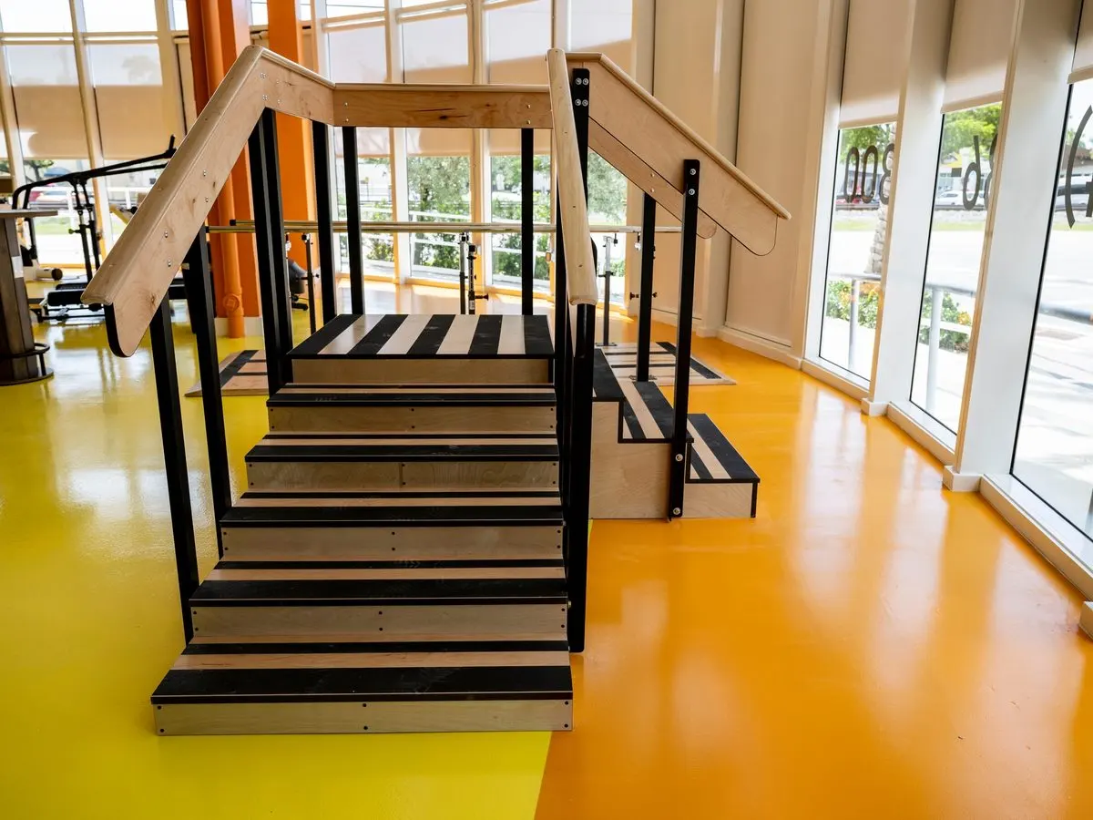 Therapeutic stairs and rail system for gait and transfer training